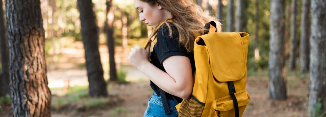 mid-shot-woman-with-backpack-forest_23-2148637047